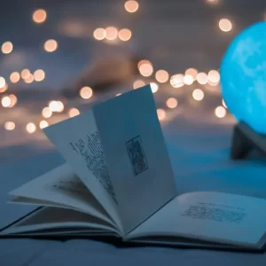 open-book-beside-blue-lamp-moon