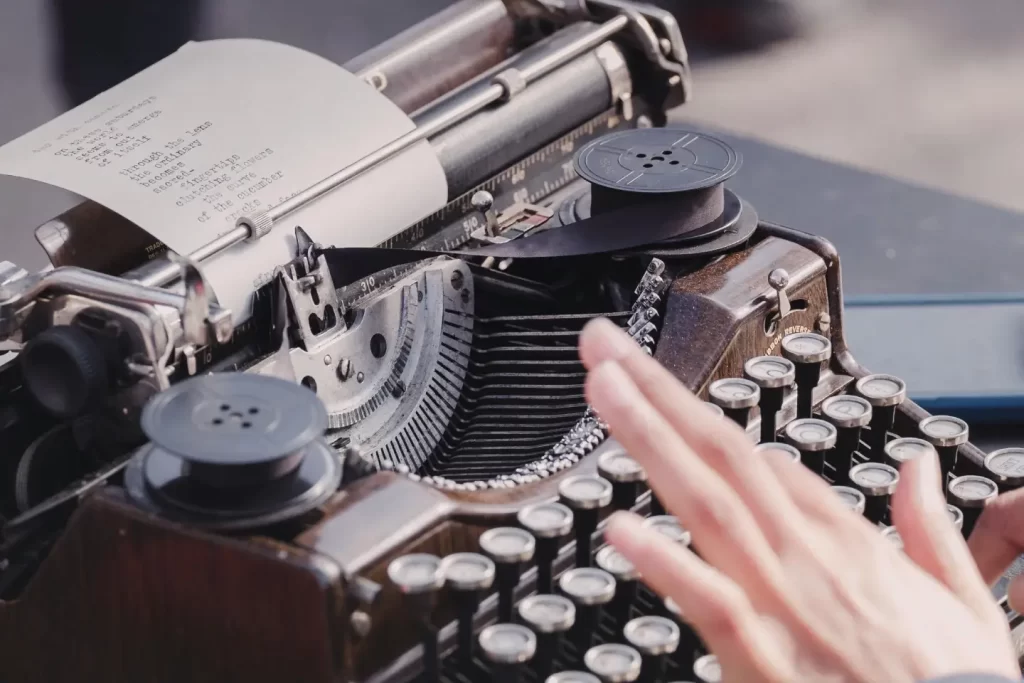 person-typing-using-typewriter